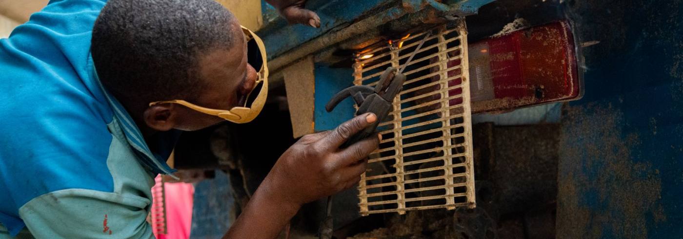Mechanic repairing a vehicle part in Lagos